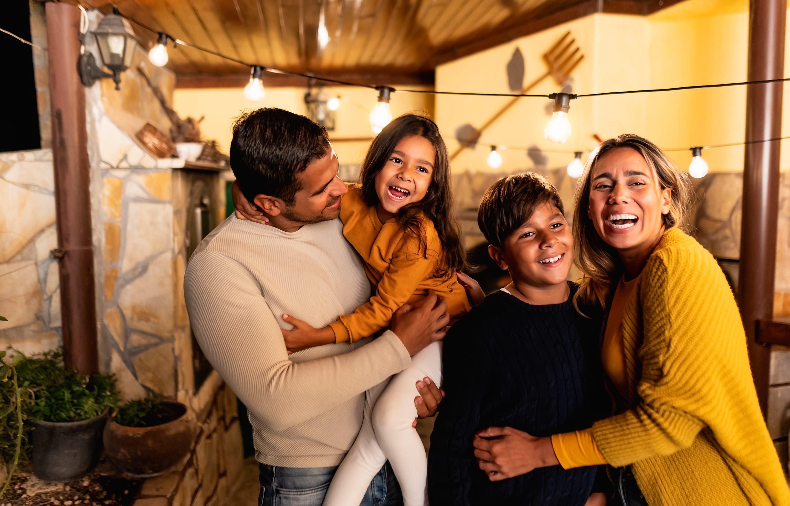 Família sorrindo em casa usando energia com desconto